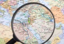 Magnifying glass focused on the Middle East map