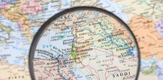 Magnifying glass focused on the Middle East map