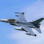 Jet fighter- flying through clear blue sky