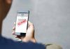 Person reading a scam message on a smartphone