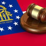 Georgia flag and judges gavel on wooden base
