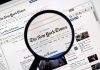 Magnifying glass over The New York Times website