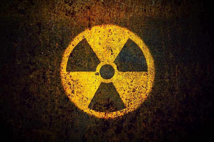1082372921 Yellow radiation warning symbol on rusty metal surface