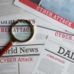 Newspapers with Cyber Attack headlines and a magnifying glass