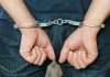 Person in handcuffs behind their back
