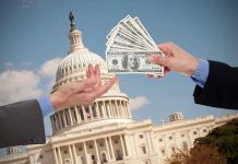 Hands exchanging money in front of Capitol building