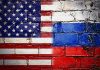 United States and Russian flags painted on brick wall
