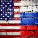 United States and Russian flags painted on brick wall