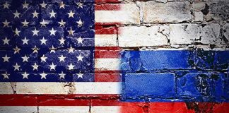 United States and Russian flags painted on brick wall