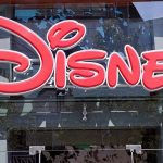 Bright red Disney logo displayed on a storefront window