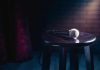 Microphone resting on a stool on stage