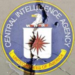 Cracked CIA logo on weathered wall