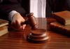 Judges gavel on desk with books