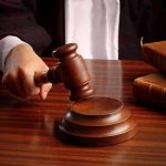 Judges gavel on desk with books