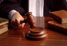 Judges gavel on desk with books