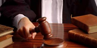 Judges gavel on desk with books