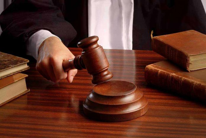 Judges gavel on desk with books