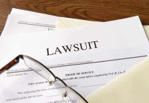 Documents labeled "Lawsuit" with glasses on top.