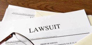 Documents labeled "Lawsuit" with glasses on top.