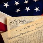 The Declaration of Independence laid on an American flag