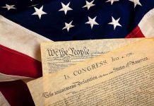 The Declaration of Independence laid on an American flag