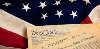 The Declaration of Independence laid on an American flag