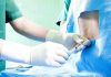 Healthcare professional administering an injection to a patient in a surgical setting