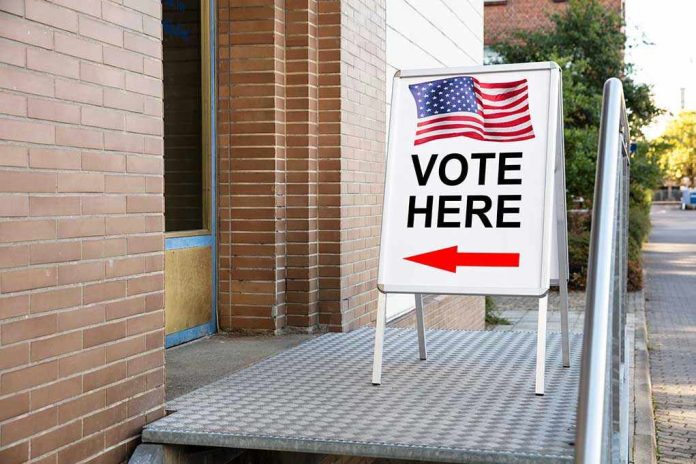 Vote Here sign with arrow and American flag