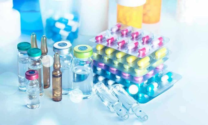 1298903665 Vials and blister packs of pills on table
