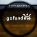 Magnifying glass over GoFundMe website logo
