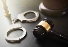 Handcuffs and judges gavel on the table