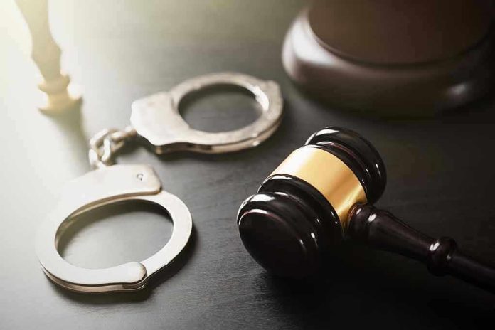 Handcuffs and judges gavel on the table