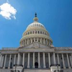 US Capitol building against a clear blue sky