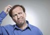 man scratching head