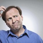 man scratching head