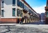 Row houses along a cobblestone street in an urban setting