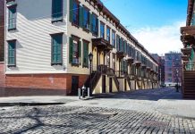 Row houses along a cobblestone street in an urban setting