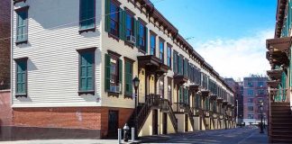 Row houses along a cobblestone street in an urban setting