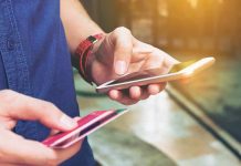Person holding a smartphone and a credit card preparing for a digital transaction