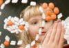 A child observing colorful pills floating in the air