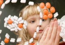 A child observing colorful pills floating in the air