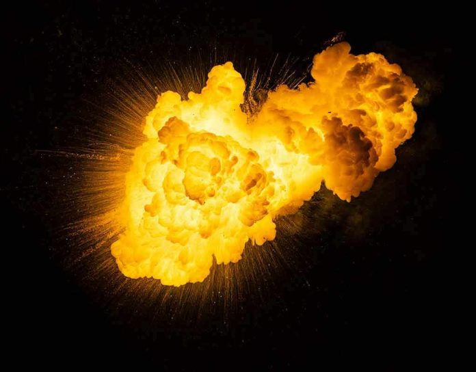 1791558833 Bright fiery explosion against a dark background
