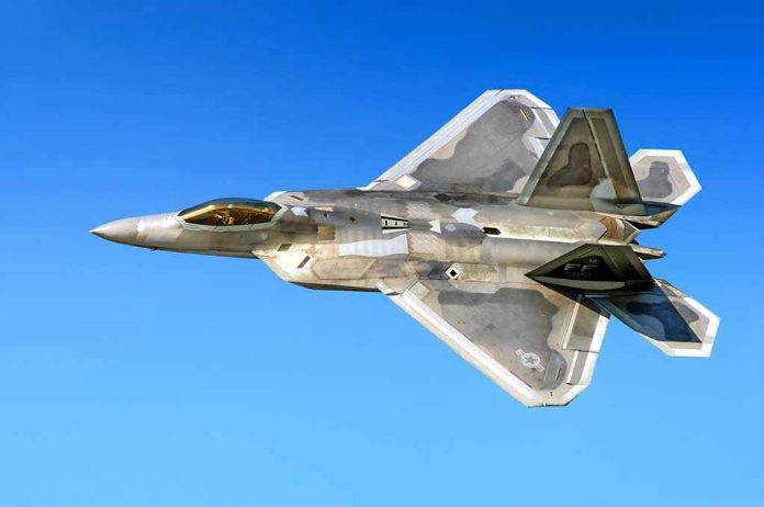 514318066 Fighter jet in flight against a clear blue sky